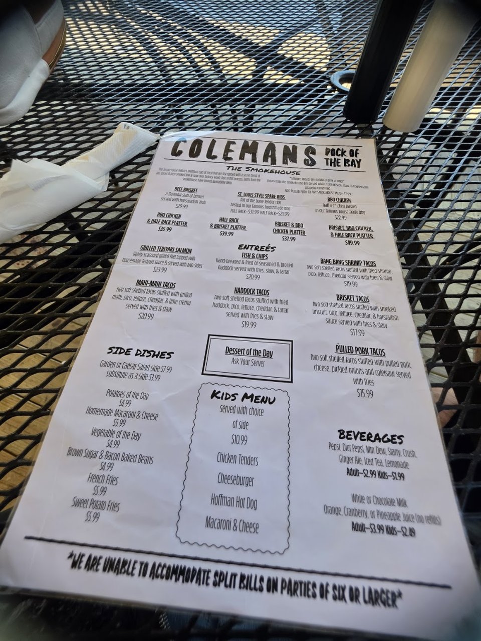 Printed menu featuring smoked meats and sandwiches.